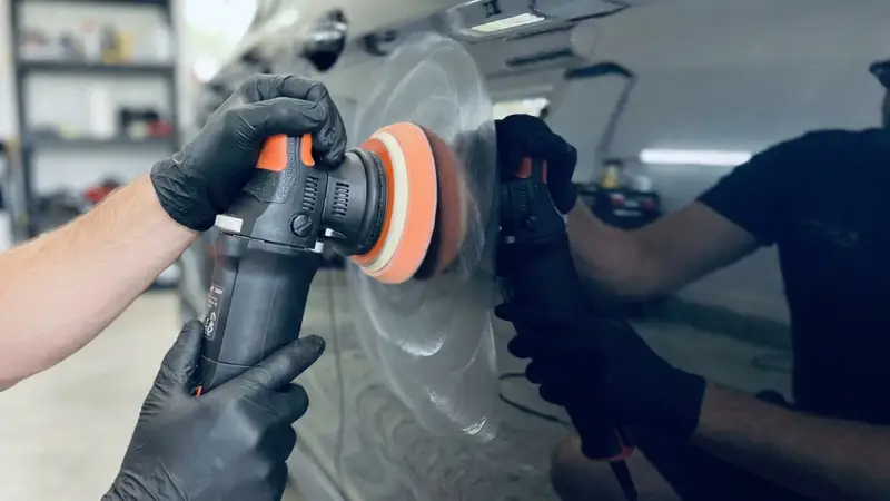 Machine polishing a car during paint correction